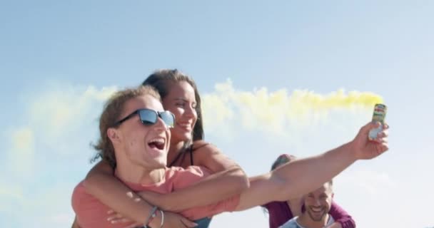 Happy couple man hold woman on piggyback at lake shore hold smoke flare achieve happiness young love concept slow motion shot on red epic w 8k. — Stock Video