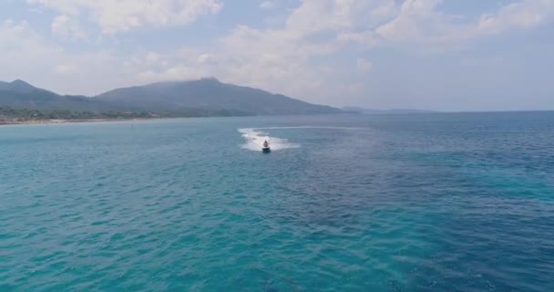 エキゾチックなギリシャの島で海でジェットスキーを運転する若い男の上に空中ビュー極端なスポーツ休暇旅行アドベンチャーエキゾチックな夏のゲッタウェイコンセプト暑い夏の日 — ストック動画