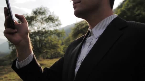 Businessman Working on Tablet Looking toward success sun flare — Stock Video