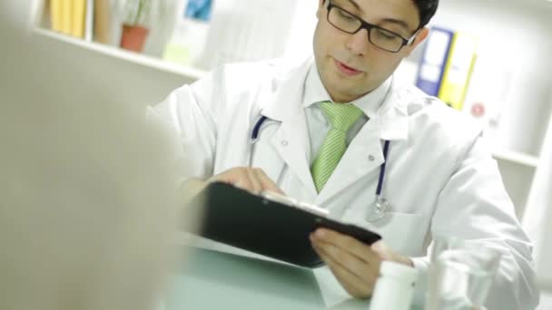 Medical Doctor Checking Patient Records and Offering Pills — Stock Video