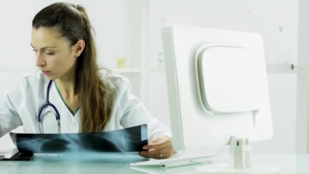 Pretty Young Woman Doctor Examining Xray — Stock Video