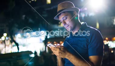 Yakışıklı adam akıllı telefon Kentsel şehir gece yazarak iletişim teknolojisi 4 g resepsiyona mesaj Sms App seyahat uygulama sosyal ağ Blogger Uhd ışıklar