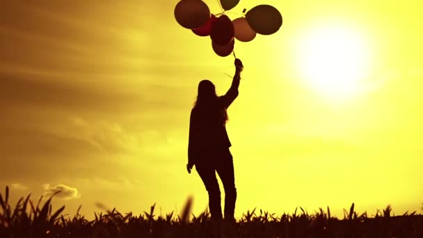 Woman with Balloons Walking on Meadow — Stock video