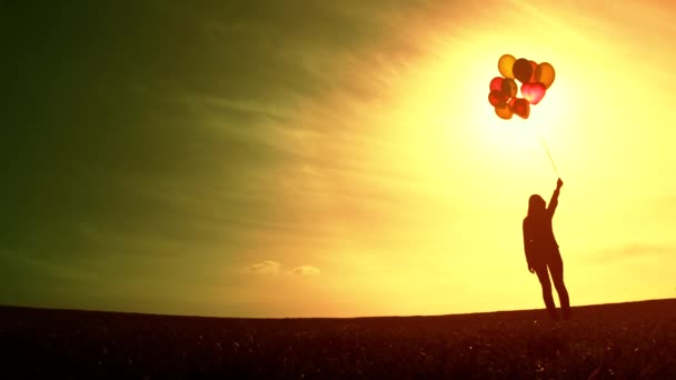 Woman with Balloons standing on Meadow — Stock video