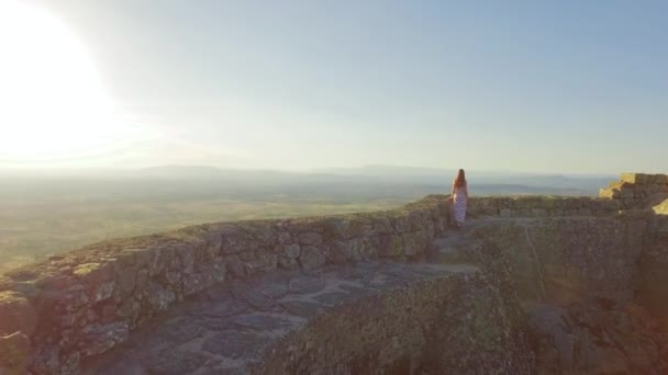 Tourist woman walking on wall surrounding castle — Stock Video