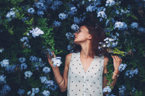 Beauty in Nature. Woman Portrait on flowers background