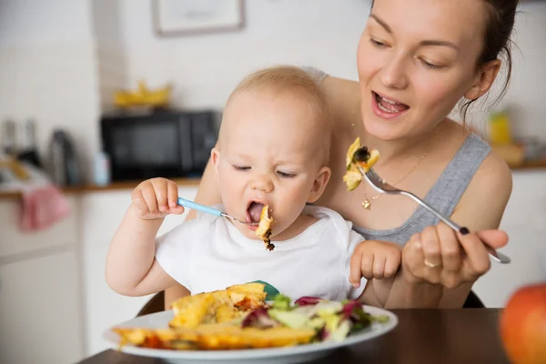 Mother and child eating together Stock Photo