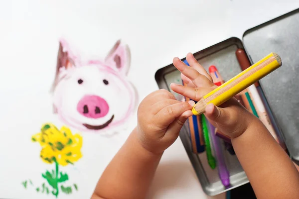 Child's hand is drawing with colorful pencils — Stock Photo, Image