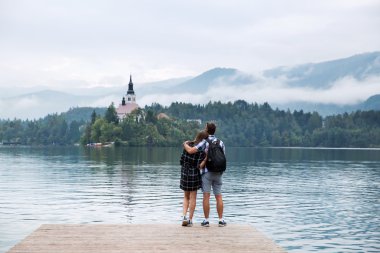 Young couple of tourists in love on the Lake Bled, Slovenia.  clipart
