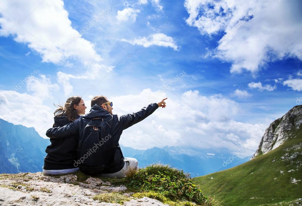 Couple of travelers on top of a mountain. Mangart, Julian Alps, Slovenia.