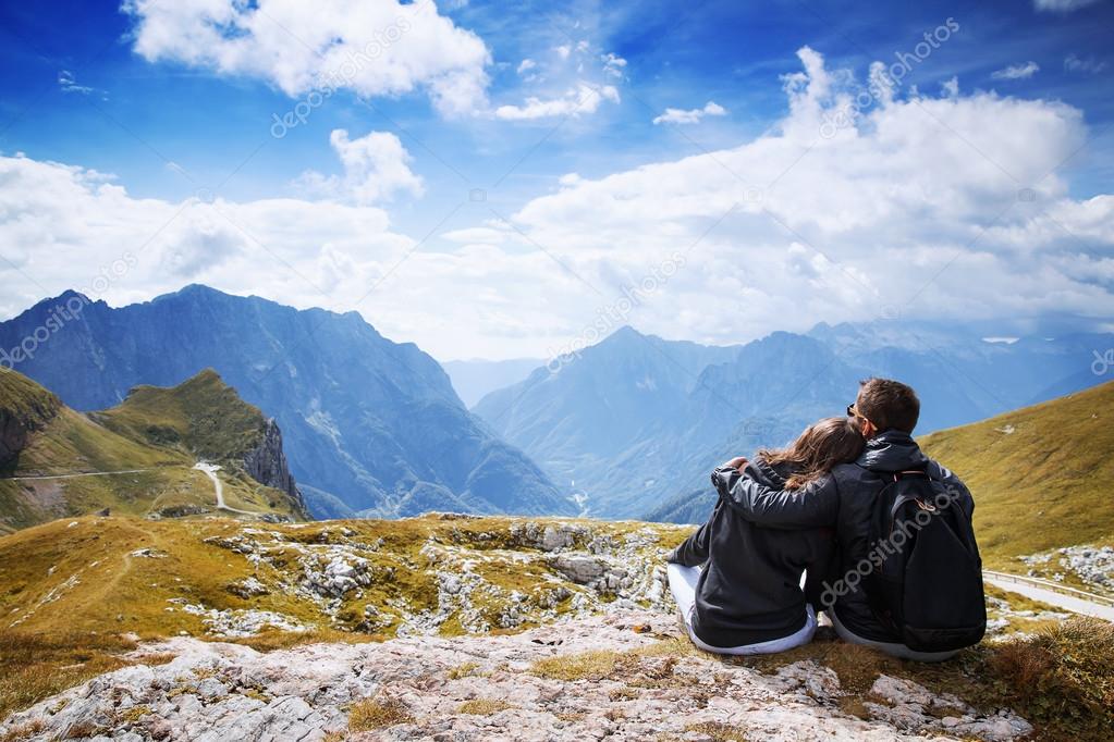 Couple of travelers on top of a mountain. Mangart, Julian Alps, Slovenia.