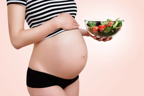 Pregnant woman with a bowl of vegetables — Stock Photo, Image