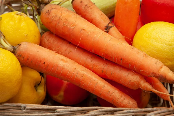 Carrots on a white background.Vitamins in the basket. apple, lemon, carrot.pumpkin