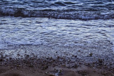 Dalgalı deniz suyu. Mısır 'daki yerel plajda deniz dalgalarıyla deniz suyu manzarası