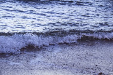 Dalgalı deniz suyu. Mısır 'daki yerel plajda deniz dalgalarıyla deniz suyu manzarası