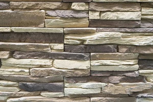 Duvardaki kaldırım taşları arkaplanı kapatın