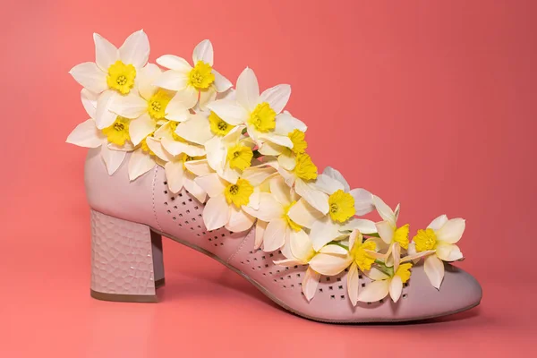 womens shoe with flowers on a pink background