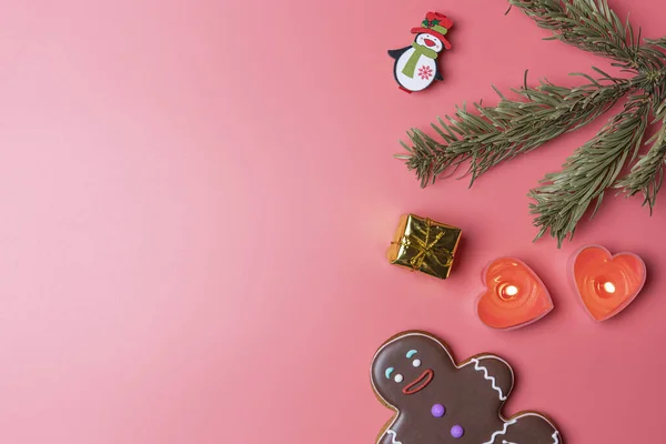 Natal brinquedos velas e biscoitos em um fundo rosa em um borrão — Fotografia de Stock