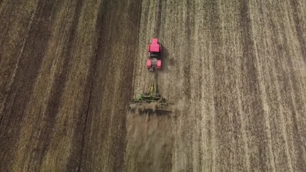 Cultivation of soil by tractor view from a height — Stock Video