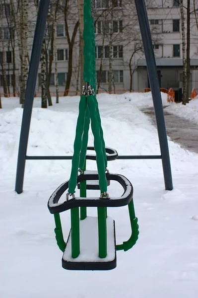 New Children Swing Snow Covered Yard — стоковое фото