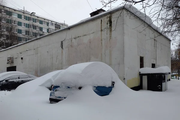 car under the snow that fell at night