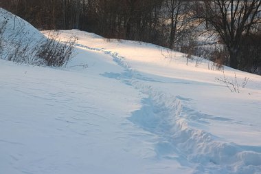 Yamaçtaki kar altında ezilmiş patika.