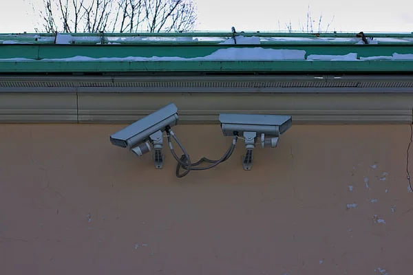 security cameras on the wall of the old building