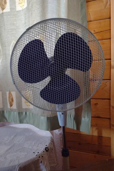 the fan in the room of the wooden country house