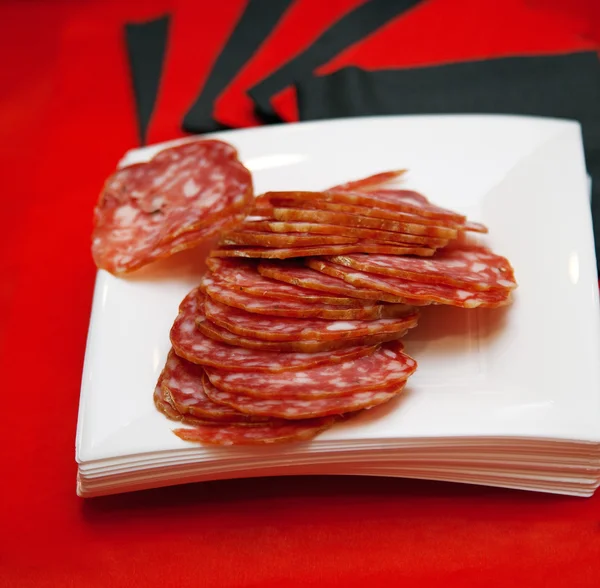 Plate with sliced of salami — Stock Photo, Image