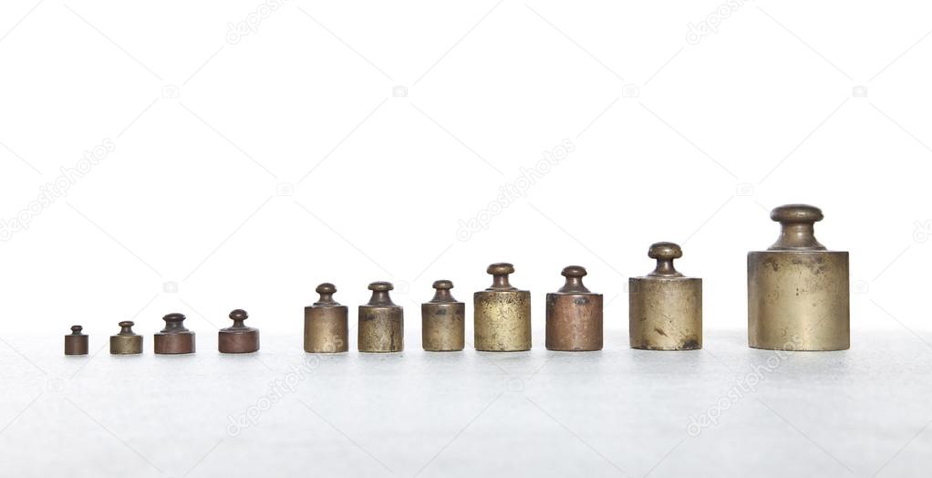 Old metal weights in row with space for your text or logo