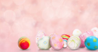 Pastel pembe arka planda boyanmış Paskalya yumurtaları.