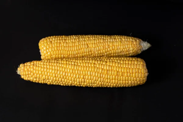 Two Yellow Corn Lie Black Background — Stock Photo, Image