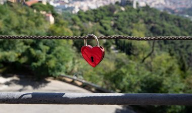 Romantic spot, a keychain commemorative lock on a guardrail hanging high above the city under the sky