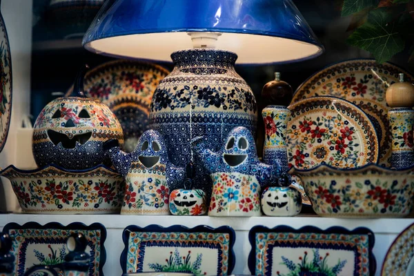 Geleneksel Polonya el yapımı çanak çömlek ve seramik sanat festivalsel Noel dekorasyonlu mağaza vitrininde güzelce düzenlenmiş. Cadılar Bayramı için balkabaklarıyla lamba ve pansuman, seramikten yapılmış, iç dekorasyon için dekorasyon