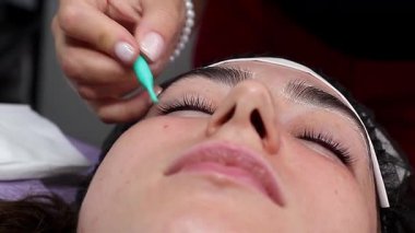 Kirpik tedavisi sırasında kadın eli ve aletlerinin yakın çekimi. Güzellik salonu prosedürleri