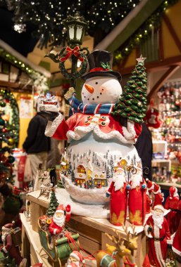 Dünyanın dört bir yanından hediyeler ve Noel süsleriyle dolu bir tatil mağazasında güzel bir kardan adam..