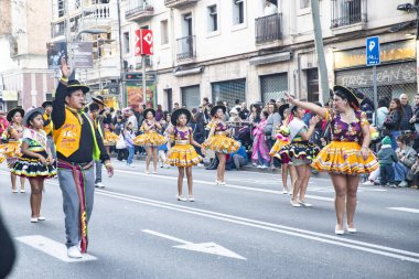 Barselona 'daki festival sokak karnavalında dünyanın farklı ülkelerinden parlak geleneksel kostümlü dansçılar yer alıyor. Barselona İspanya 14.02.2026