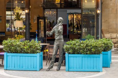 Baku, Azerbaijan. This violinist sculpture is one such decorative work, created by Azerbaijani sculptors at the citys request. Its purpose is not linked to a specific real person or historical figure.