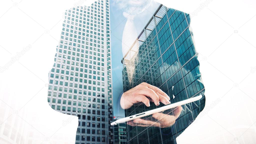 Business concept, double exposure of London city office buildings and businessman using tablet, white background