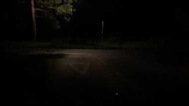 van driving empty country lane at night