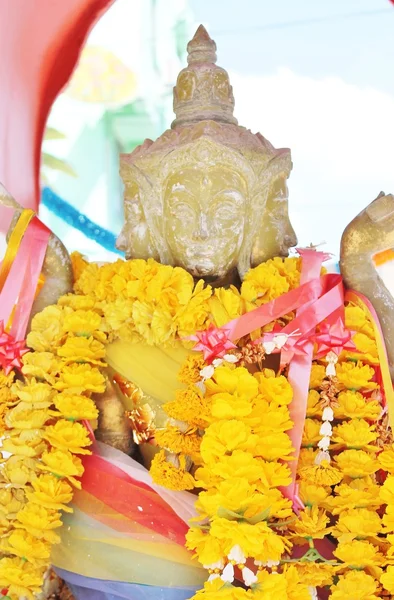 Estatua de buddha con guirnalda colorida — Foto de Stock