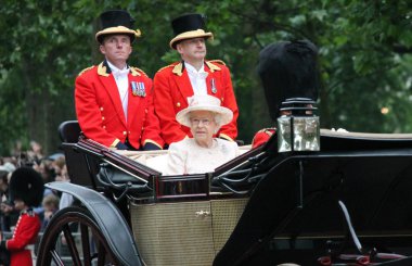 QUEEN ELIZABETH, TROOPING THE COLOUR, LONDON - JUNE 13: Queen Elizabeth II and Prince Philip seat on the Royal Coach at Queen's Birthday Parade, also known as Trooping the Colour, on June 13, 2015 in London, England. clipart
