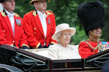 Queen Elizabeth & Prince Philip LONDON - JUNE 13: Queen Elizabeth II and Prince Philip seat on the Royal Coach at Queen's Birthday Parade, also known as Trooping the Colour, on June 13, 2015 in London, England. clipart