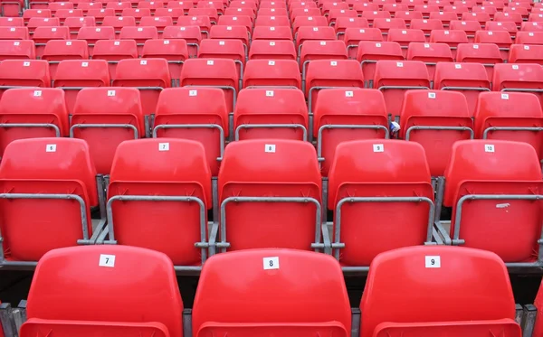 Stadium seats red empty in lines folded — Stock Photo, Image