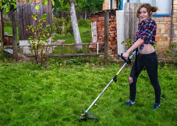 Woman in Plaid Shirt Mowing Lawn Stock Picture