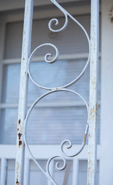 Close up of an old fashioned white porch screen door