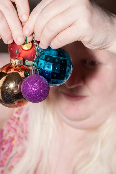 Woman Preparing Hang Red Poinsettia Gold Purple Blue Globes Holidays — Stock Photo, Image