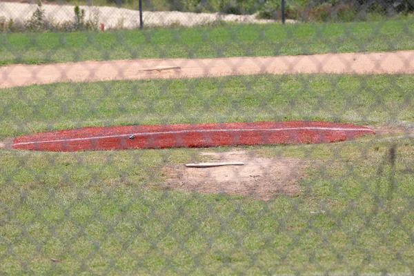 Empty pitcher\'s mound in an empty baseball field