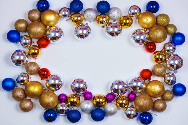 Gold, blue, red and silver glitter Christmas balls pattern. Flat lay, top view, copy space. Christmas golden,red,violet, blue and silver balls decorations on white background. New year creative arrangement frame.