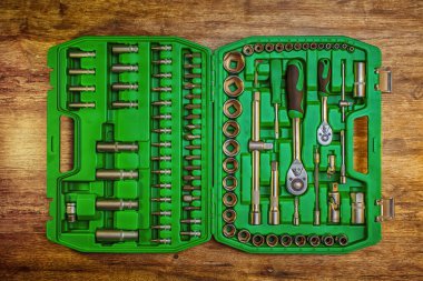 Ahşap tezgahta farklı enstrümanların bulunduğu alet kutusunu aç. Ahşap arka planda farklı çalışma araçları. Üst Manzara. El aleti. Araç gereç erkek işyeri arka plan dokusu koyu ahşap. 